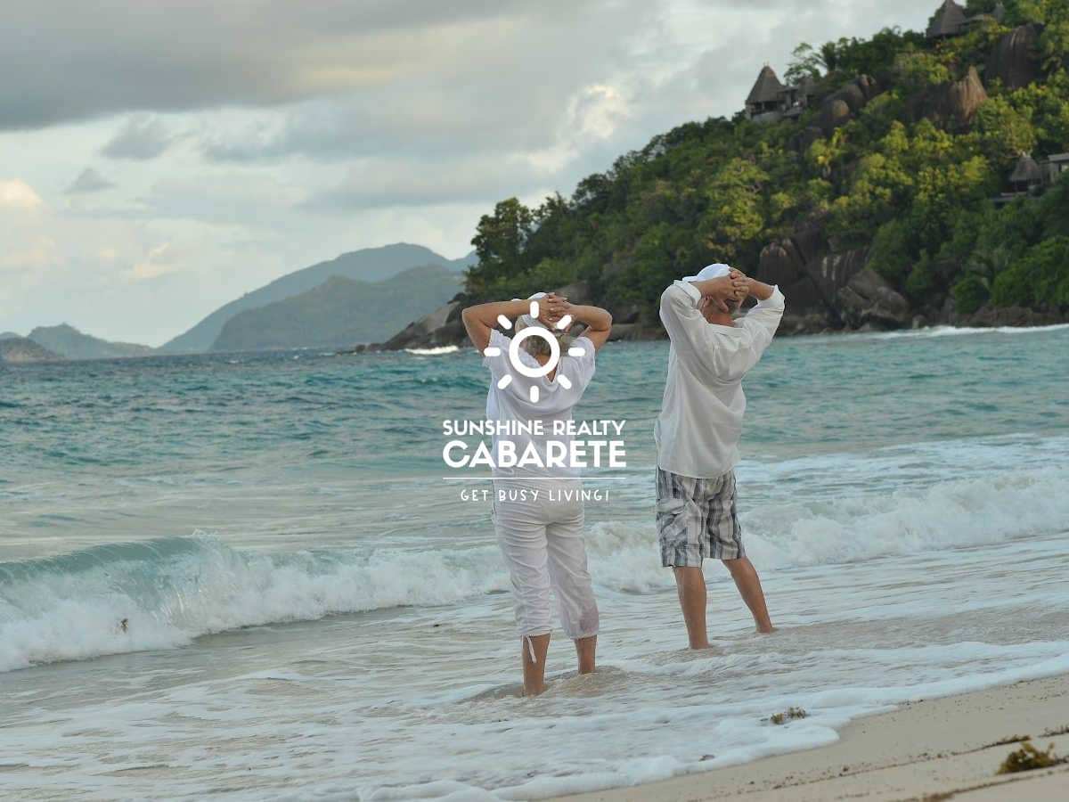 An image of a retired couple doing exercises on Cabarete beach in Dominican Republic