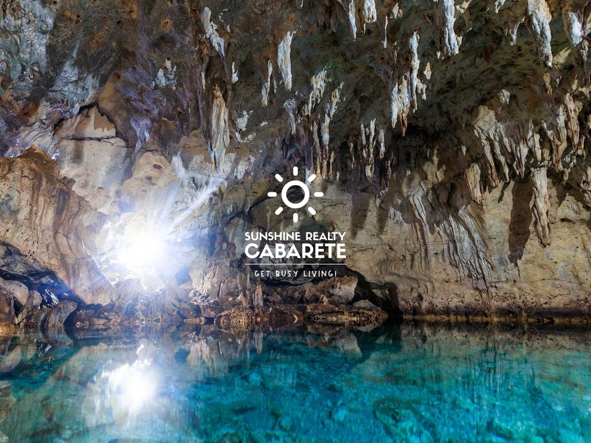 Image taken from inside the Cabarete caves with water on the floor and stalactites.