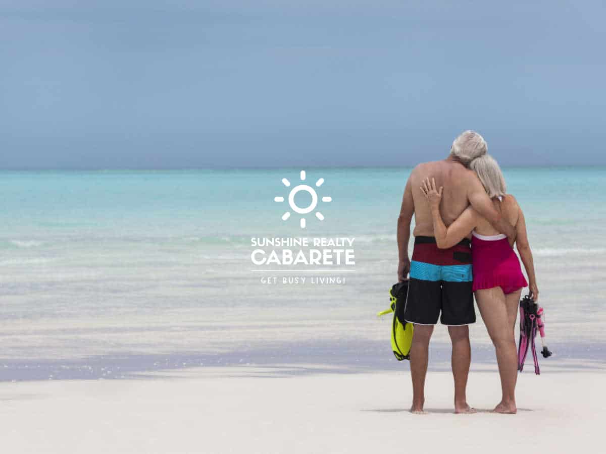 Image of a retired couple staring at the ocean on Cabarete beach