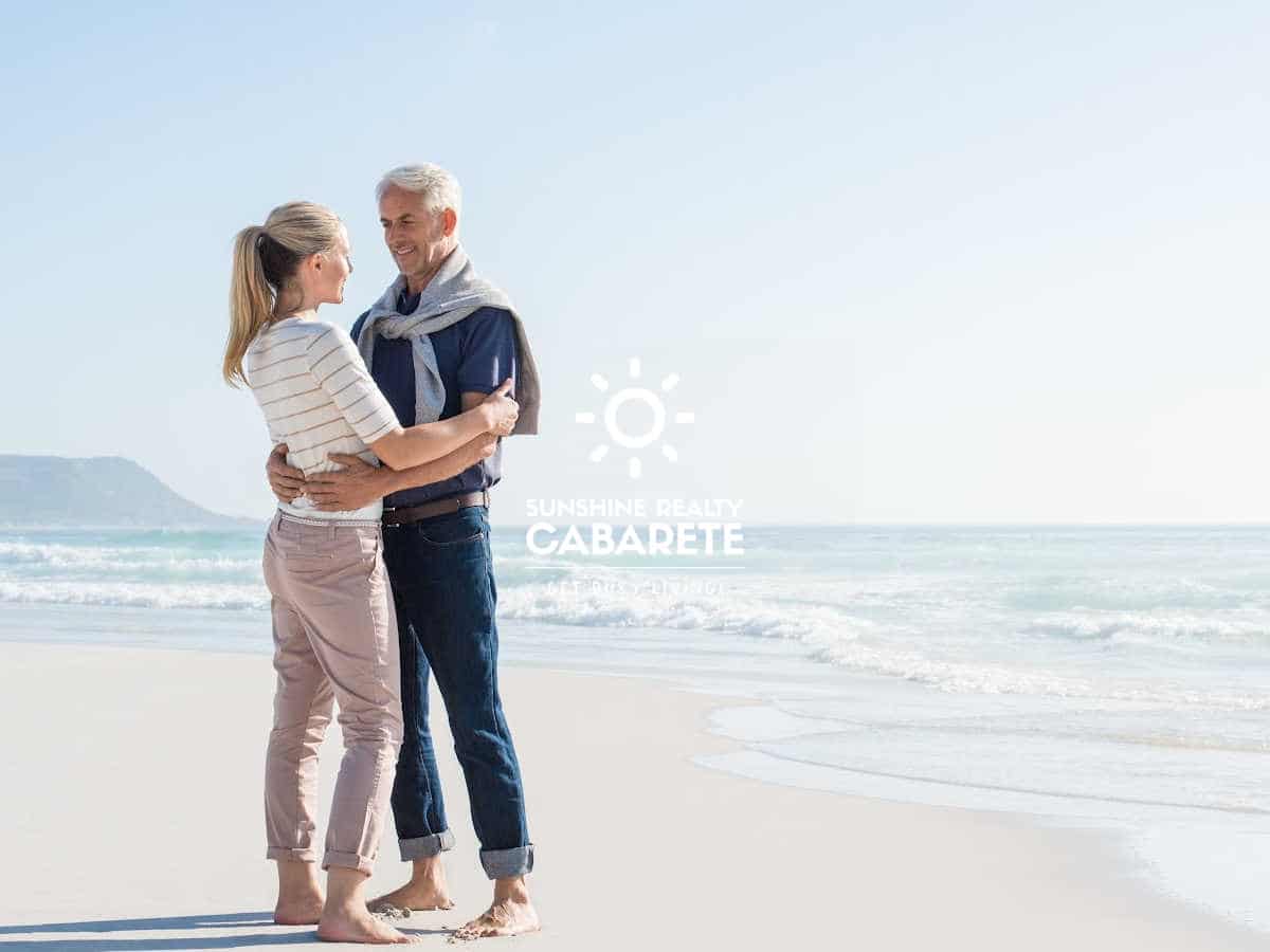 Image of a retired couple walking on the beach in Cabarete